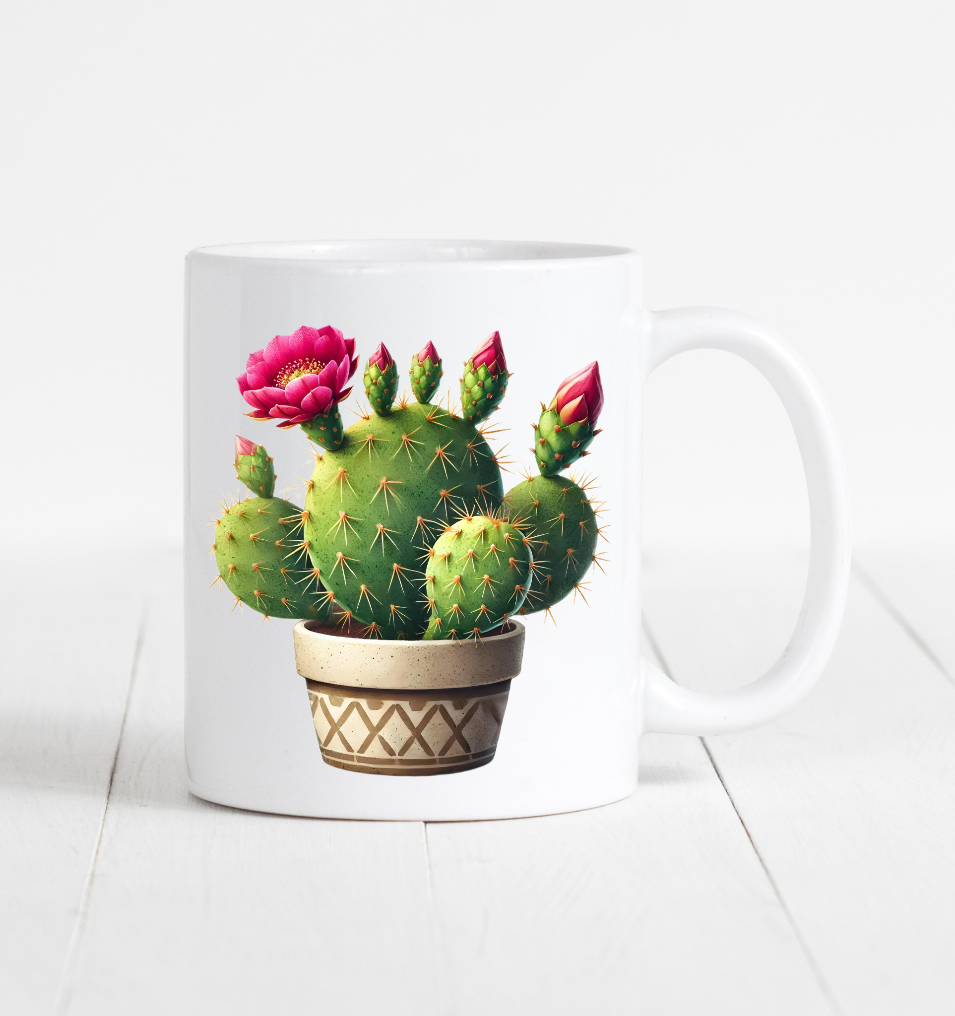 witte mok met de afbeelding van een cactus met roze bloemen in een bruine pot